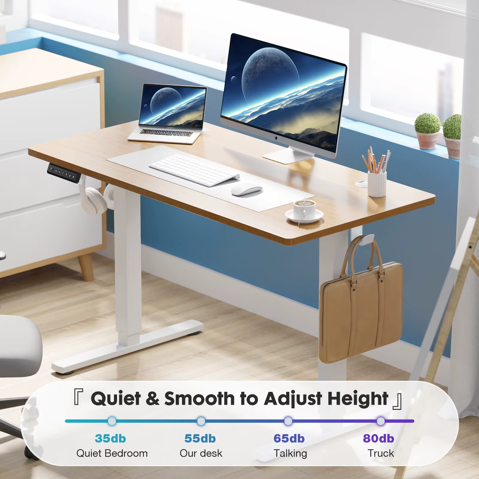 Electric standing desk with laptop and monitor in bright office setting